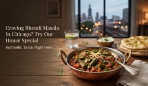 Ad for Bhendi Masala in Chicago: copper skillet of spiced vegetables on a wooden table, naan nearby, city lights in the window, and text on left.